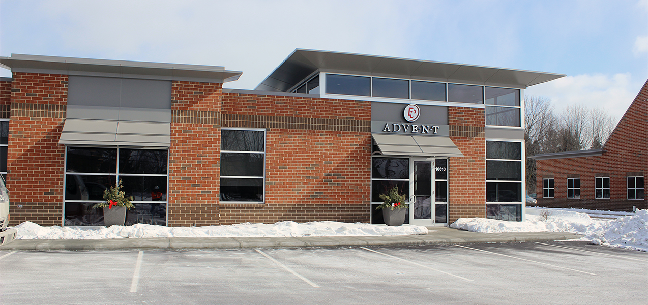 Front of Advent building with parking spaces in the snow in Mequon, WI, as Tri-North Builders project.
