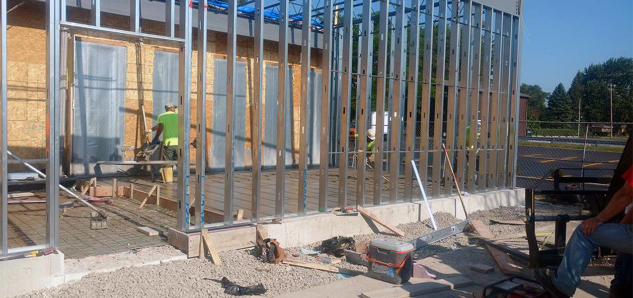 A Tri-North team member works within the framed out walls of a new ALDI store.
