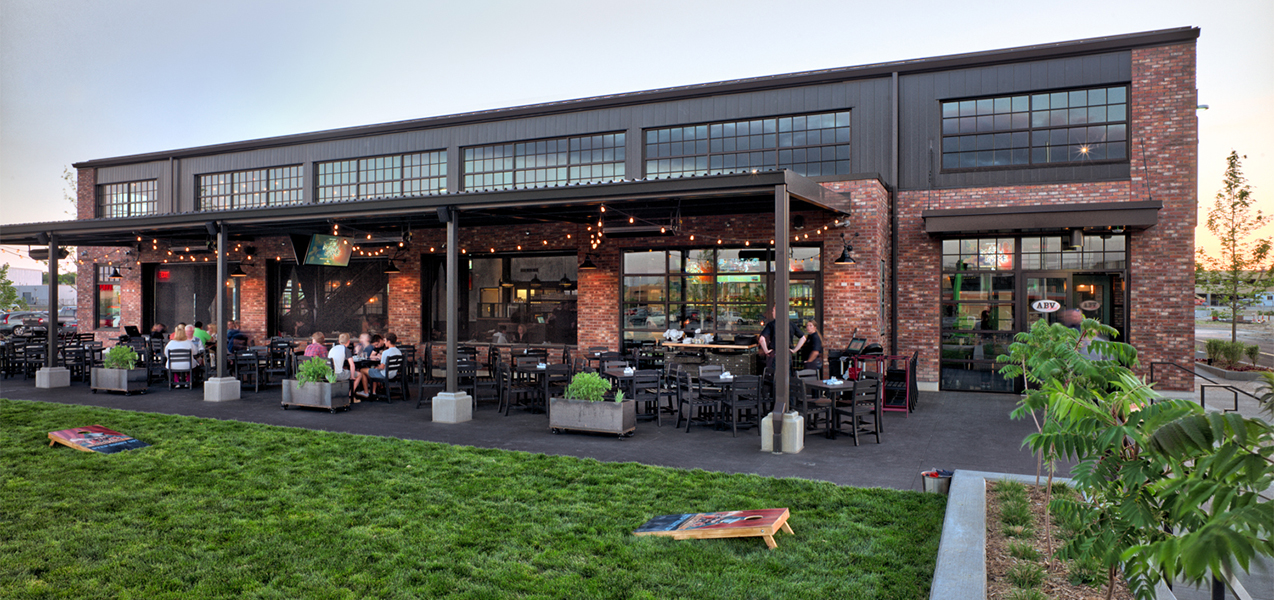 Back patio and outdoor seating with games for ABV Social restaurant in Wisconsin as built by Tri-North Builders.