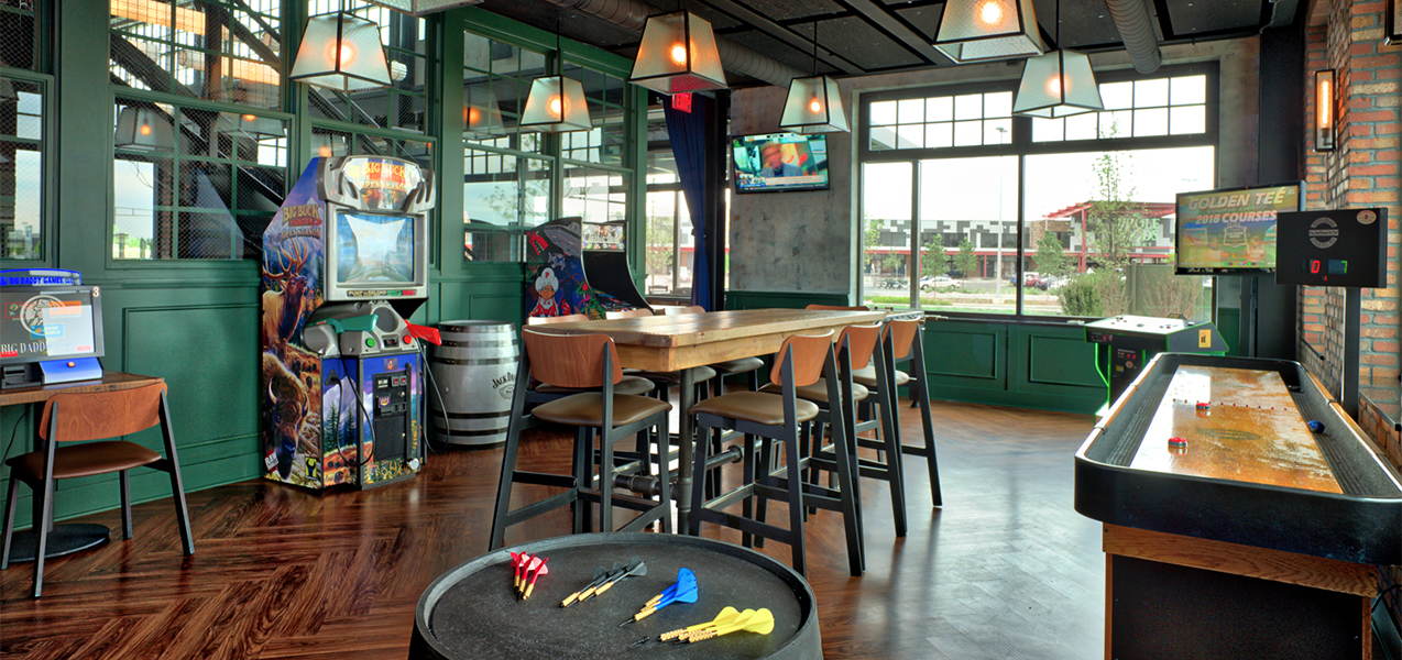 Game room with table and chairs inside the Bartolotta Collection restaurant ABV Social built by Tri-North Builders.