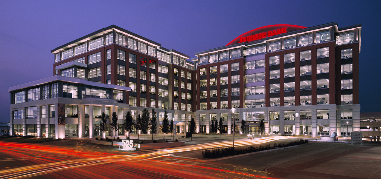 Nighttime shot of City Center West building with courtyard which was built by Tri-North Builders in Wisconsin.