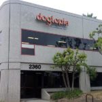 The Dogtopia logo can be seen at the top of a two-story building housing a Dogtopia location.