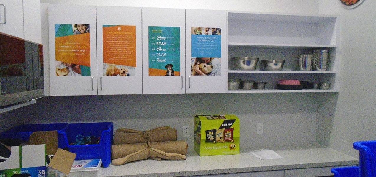 Cabinets and sheves house pet supplies at a Dogtopia built by Tri-North.