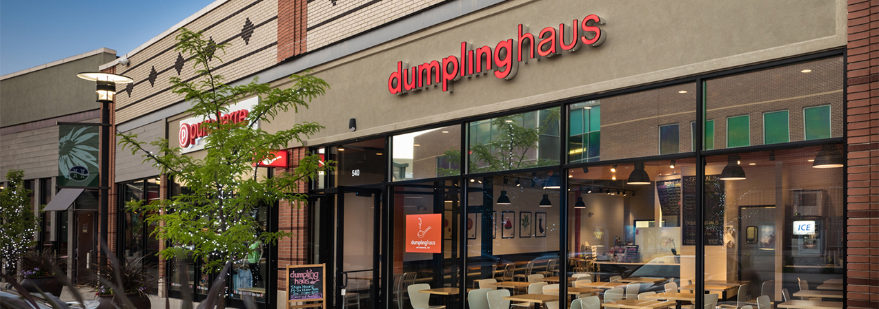 Front entrance and windows of Dumpling Haus restaurant including patio showcasing Tri-North Builder's work.