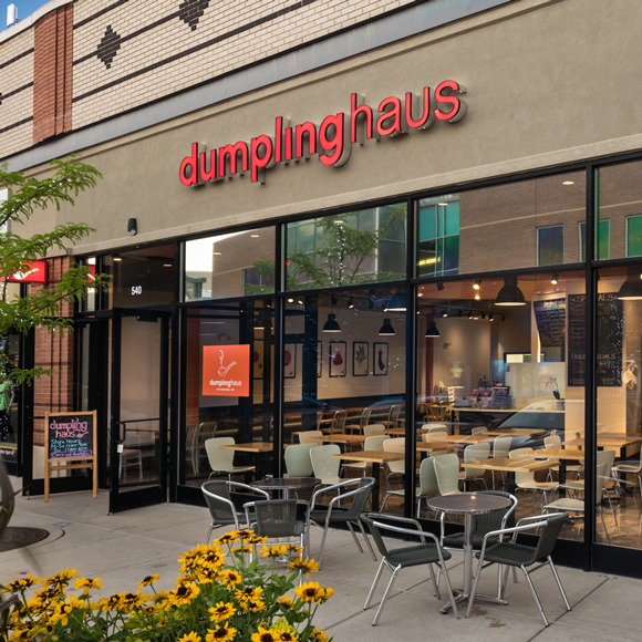 Exterior, front window, entrance and patio for the Dumpling Haus in Wisconsin.