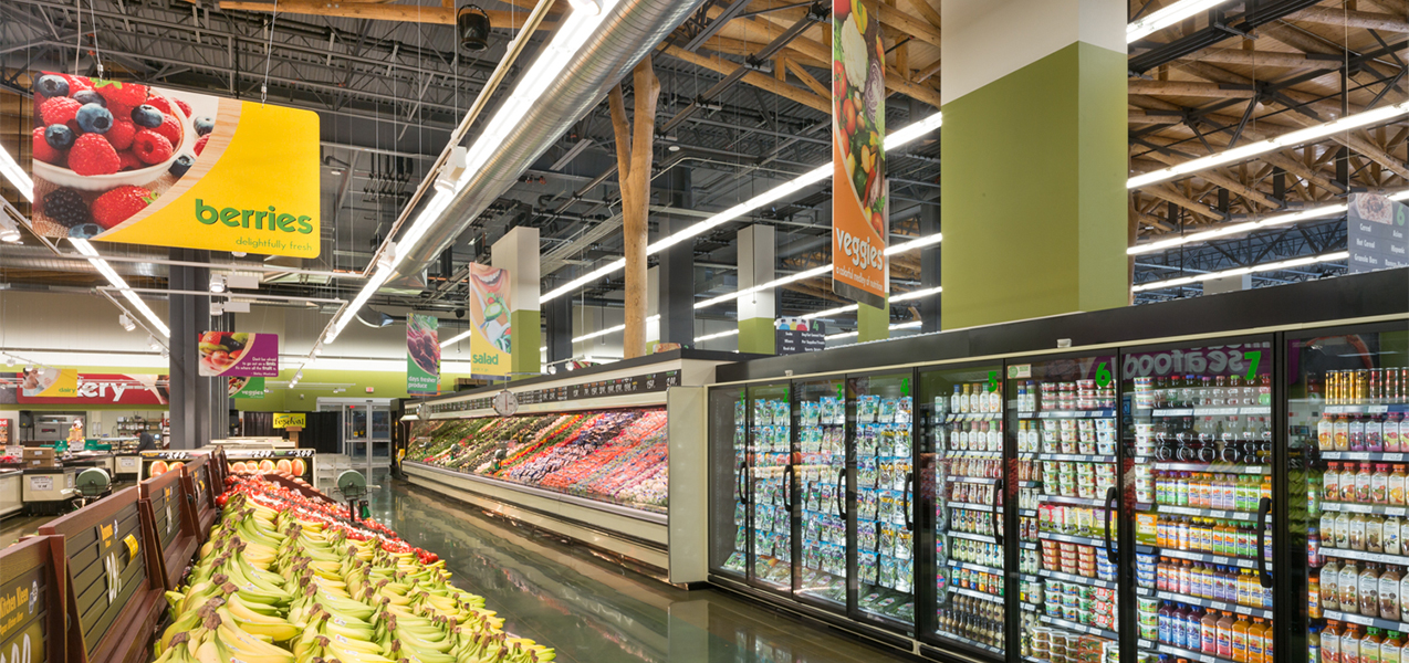 The Festival Foods produce sections features rows of stocked coolers.