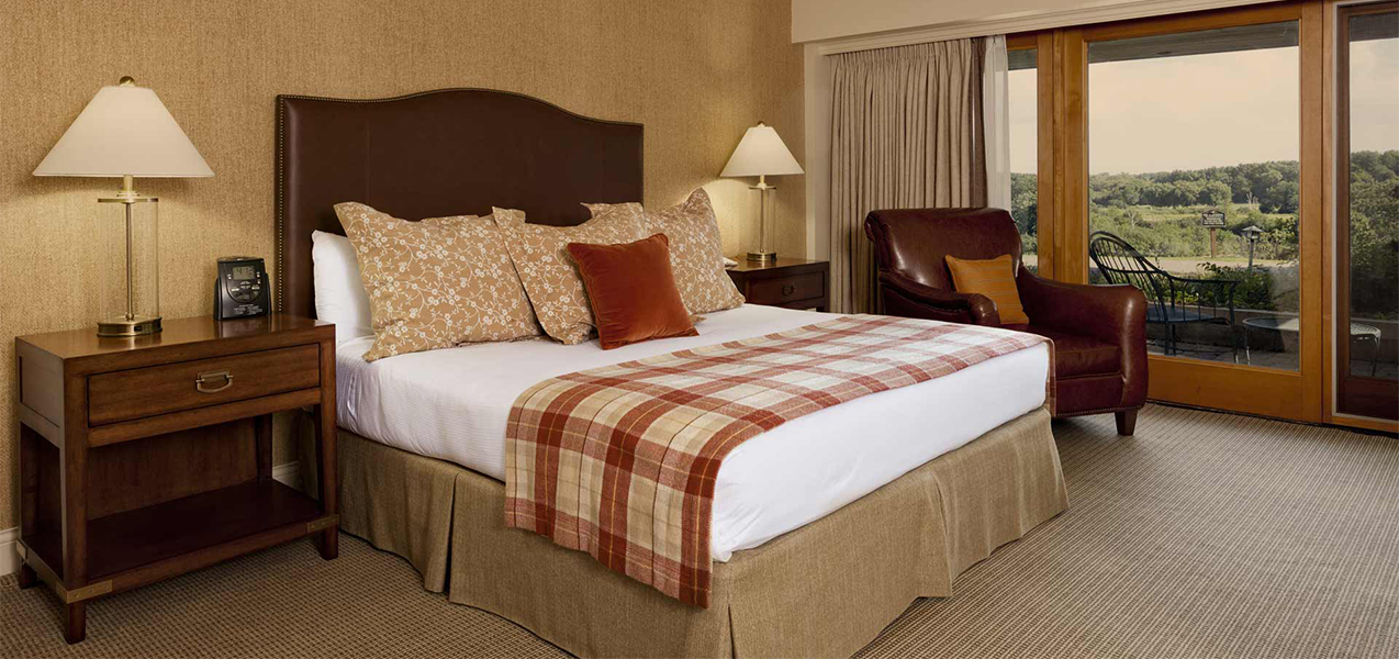 King sized bed inside a Tri-North Builders remodeled hotel room at the Grand Geneva Resort & Spa.