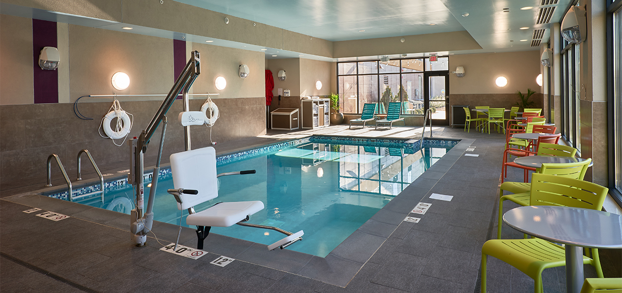 Handicapped accessible pool and chairs at the Home2Suites by Hilton Madison Central Alliant Energy Center project.