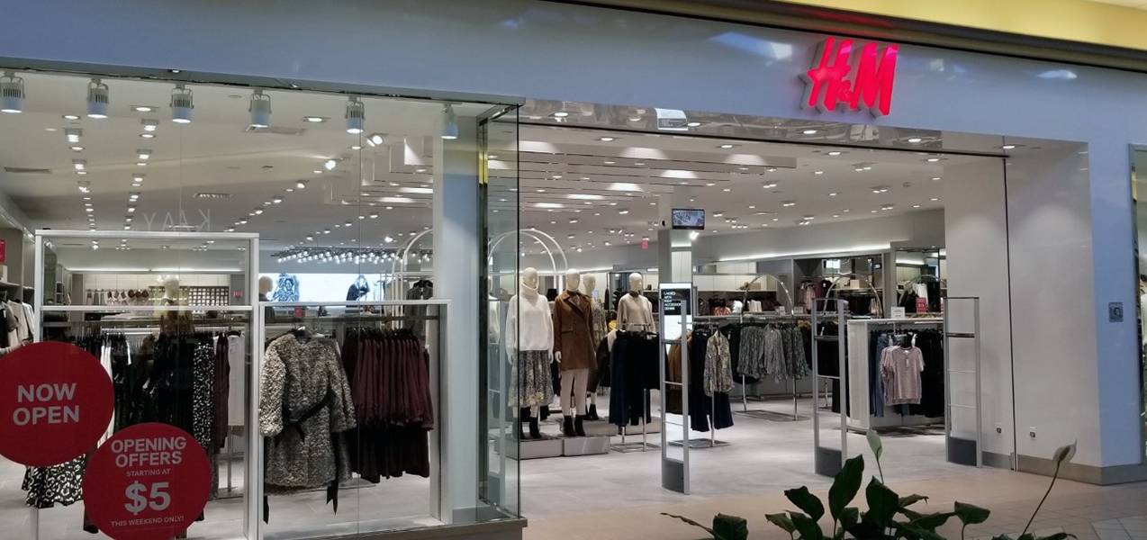 A view into the front entrance of an H&M store built by Tri-North shows clothing on display.