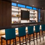 Tri-North Builders remodeled bar with bar stools inside the Hilton Garden Inn Milwaukee Brookfield Conference Center.