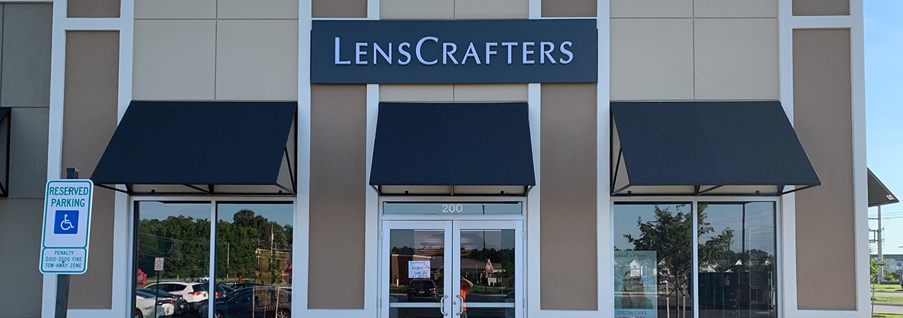 The LensCrafters sign is installed above the front entrance to this location, built by Tri-North.