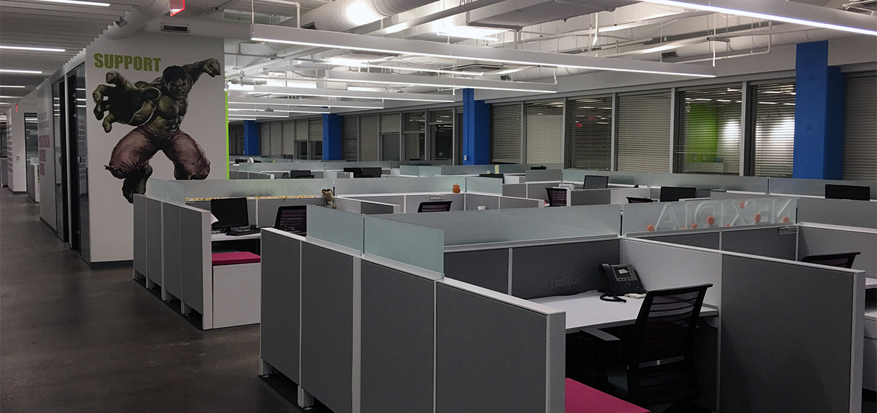 Cubicles fill a large open area at the heart of the NICE office in Richardson, Texas.