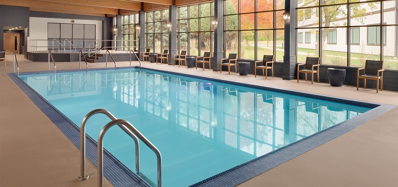 Indoor pool and seating area inside the Radisson Hotel & Conference Center Green Bay in Wisconsin.