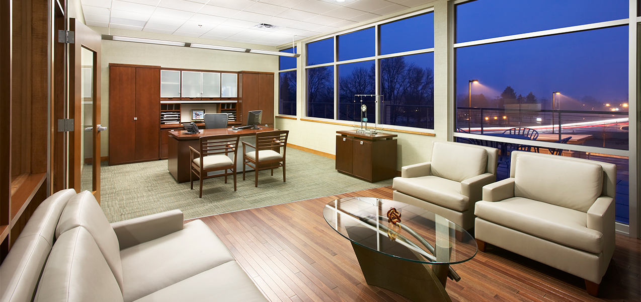 Large executive office with sitting area inside the Tri-North Builders headquarters in Wisconsin.