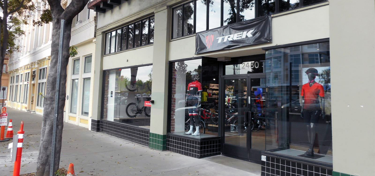 Mannequins and bikes are seen in the entrance windows of a Trek bike store built by Tri-North.