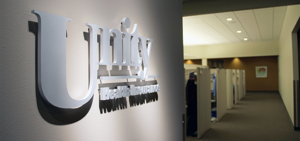 Unity Health Insurance offices with cubicles and sign at the Tri-North Builders UW Health Office project.