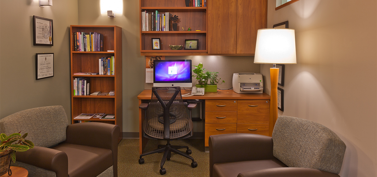 Office area with desk, computer and chairs inside the Tri-North Builders remodeled UW Cancer Center in Madison, WI.