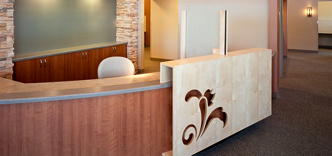 Reception desk and registration area inside the Tri-North Builders remodeled UW Health Stoughton Clinic.
