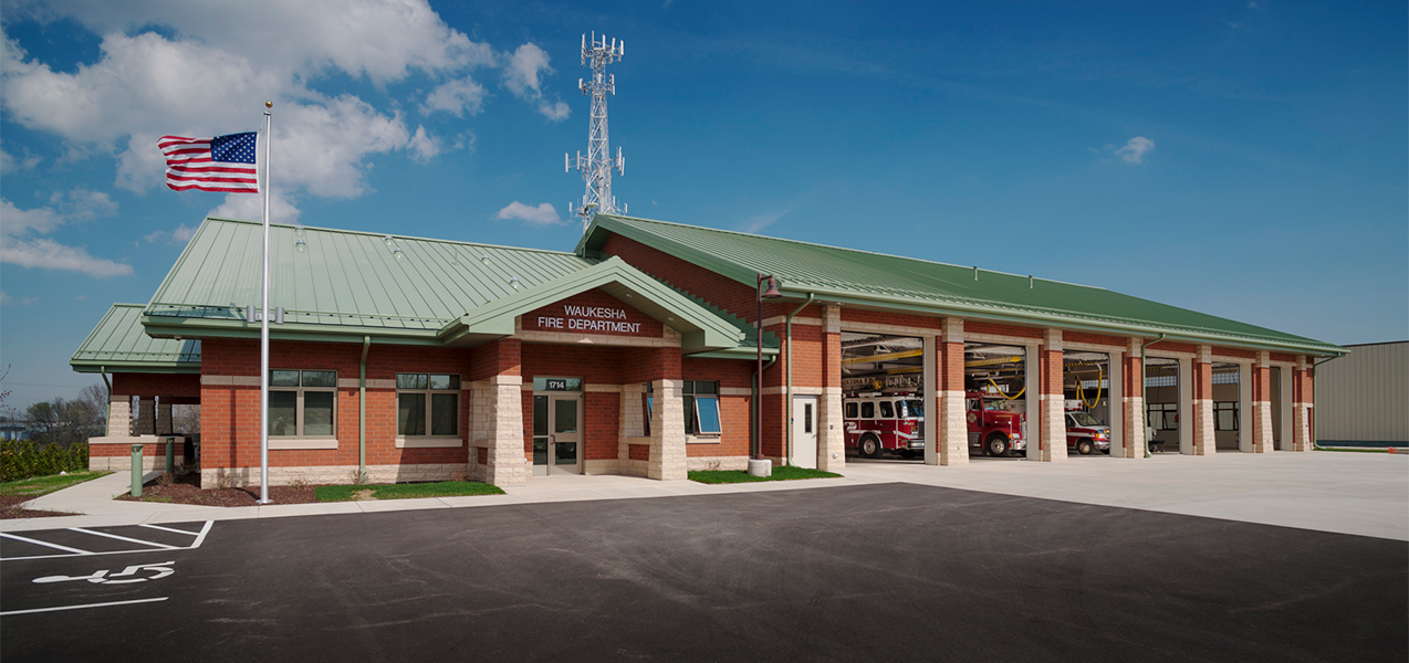 Front of building at Tri-North Builders' Waukesha Fire Department remodel project with fire trucks and garage doors.
