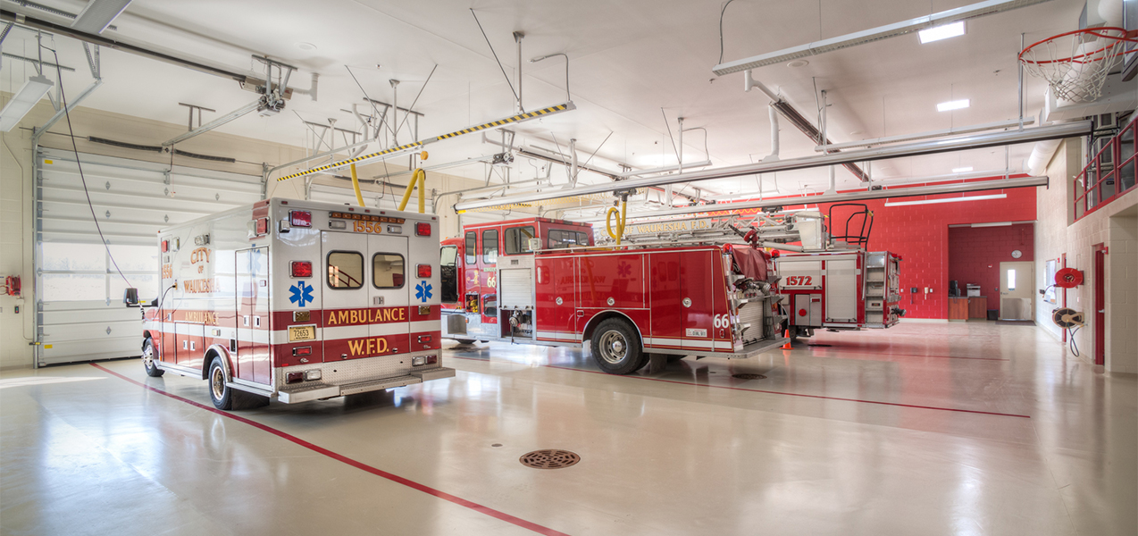 Interior of garage at Waukesha, WI, fire department showing fire truck and ambulance, a Tri-North project.
