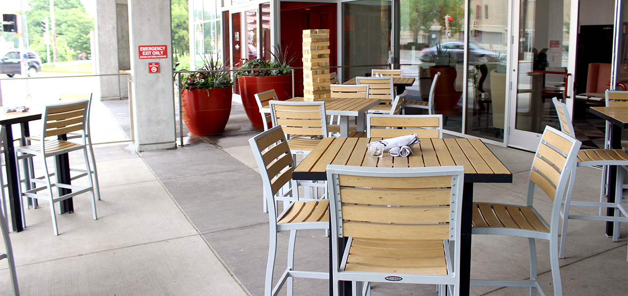 Outdoor patio tables and chairs at The Wise at Hotel Red restaurant in Madison, WI.