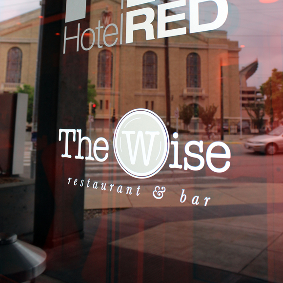The Wise at Hotel Red front window with logo in Madison, WI, a Tri-North Builders project.