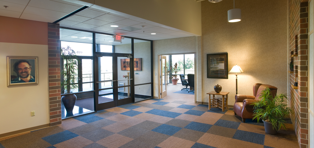 Double glass doors welcome visitors into the lobby of the PIKE Technologies building built by Tri-North.