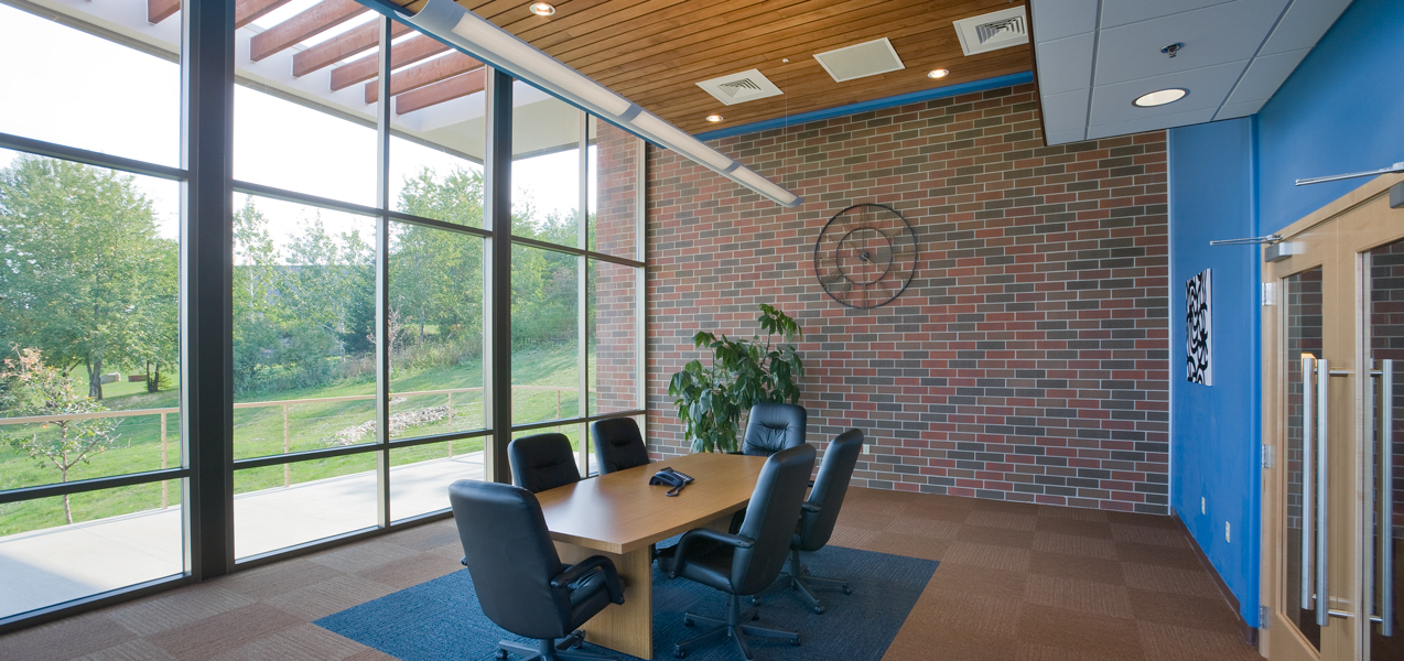 A wall of windows allows lots of light into a PIKE Technologies conference room.