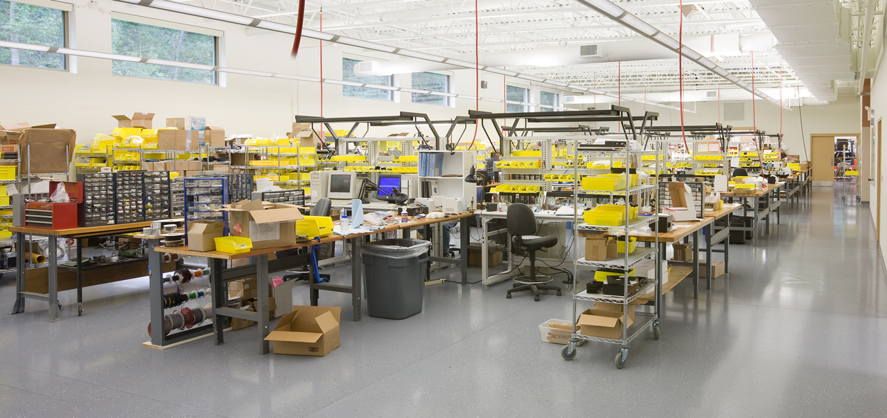 Desks, tables and carts of supplies fill the assembly room at PIKE Technologies in Fitchburg, WI.